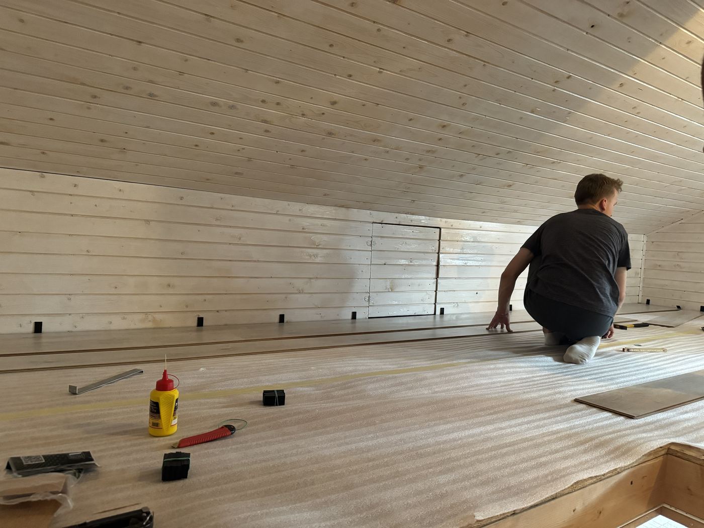 Laying the laminate over the underlay along the low wall