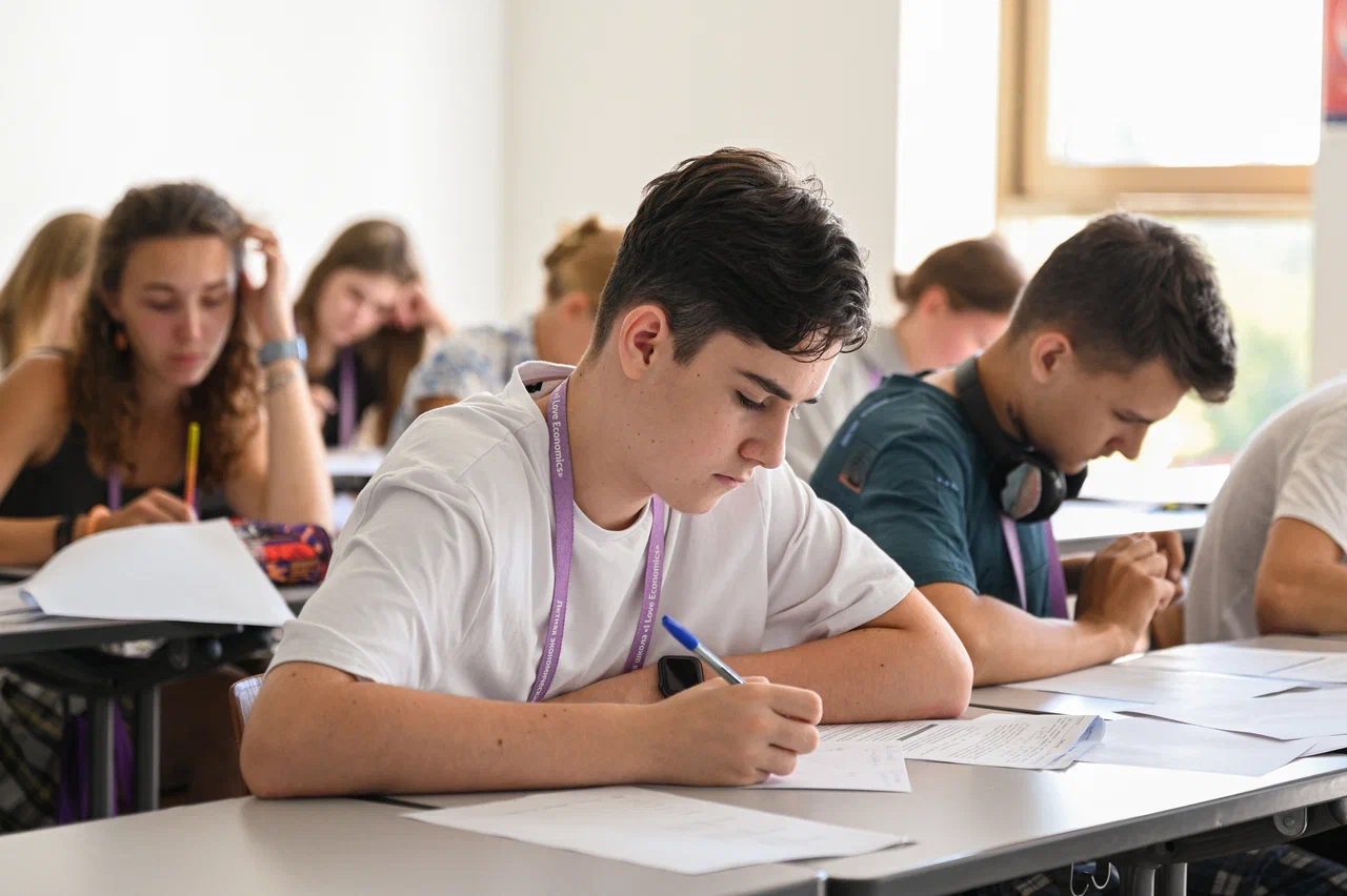 Me writing an exam paper in a classroom at the summer school