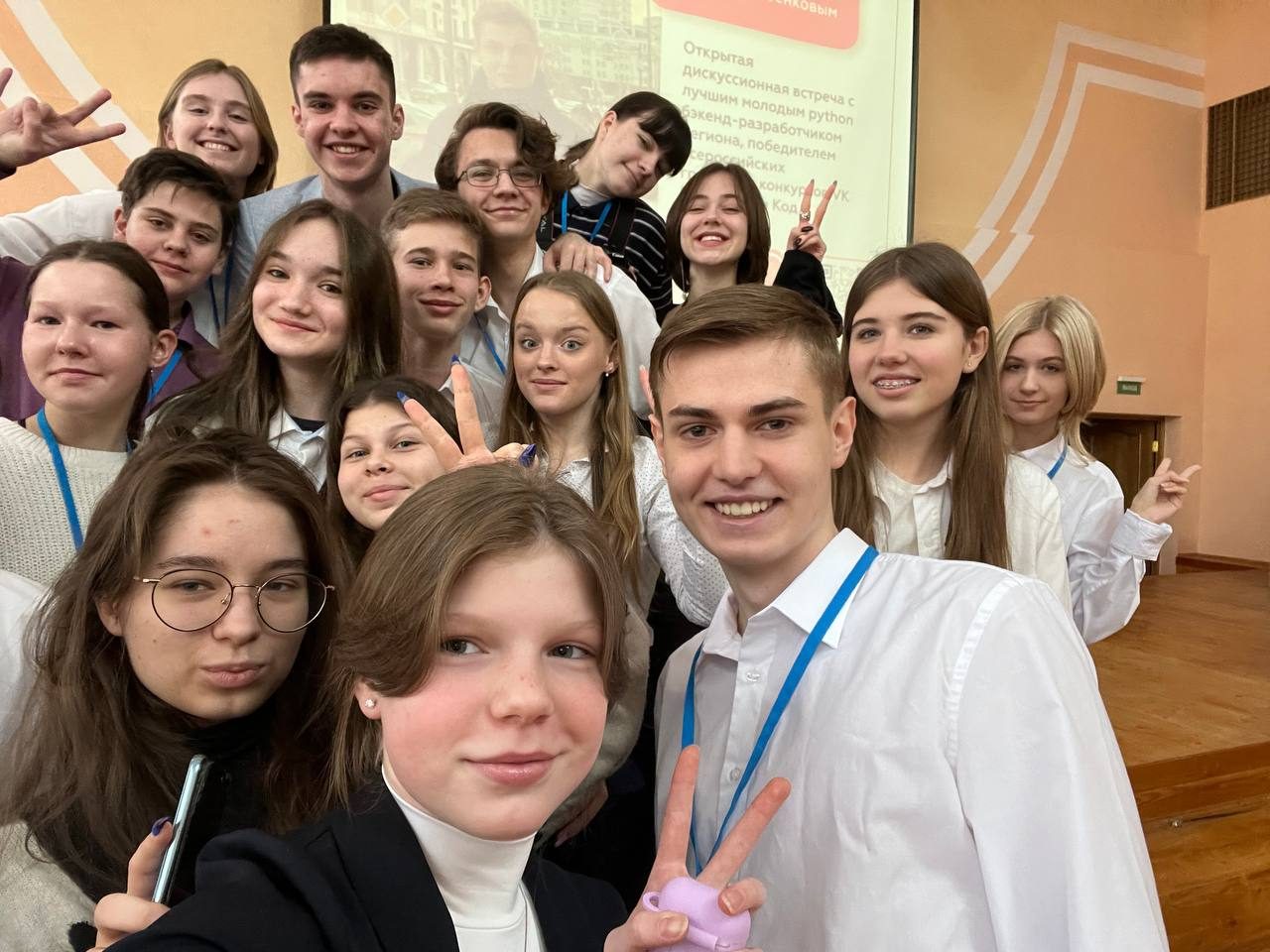 Members of the media department taking a group selfie in the assembly hall before an event