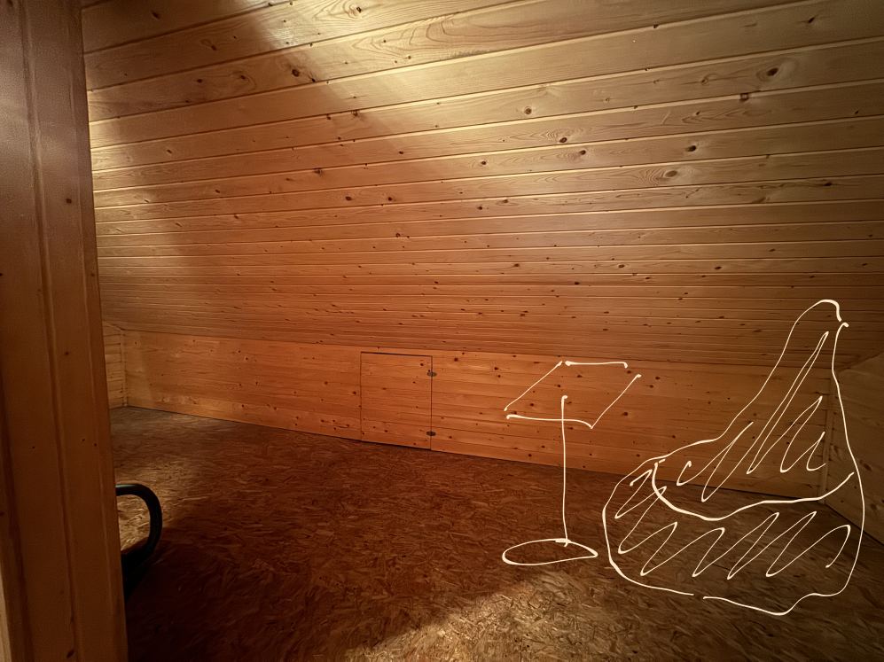 A bean bag and a floor lamp drawn into a corner of the loft