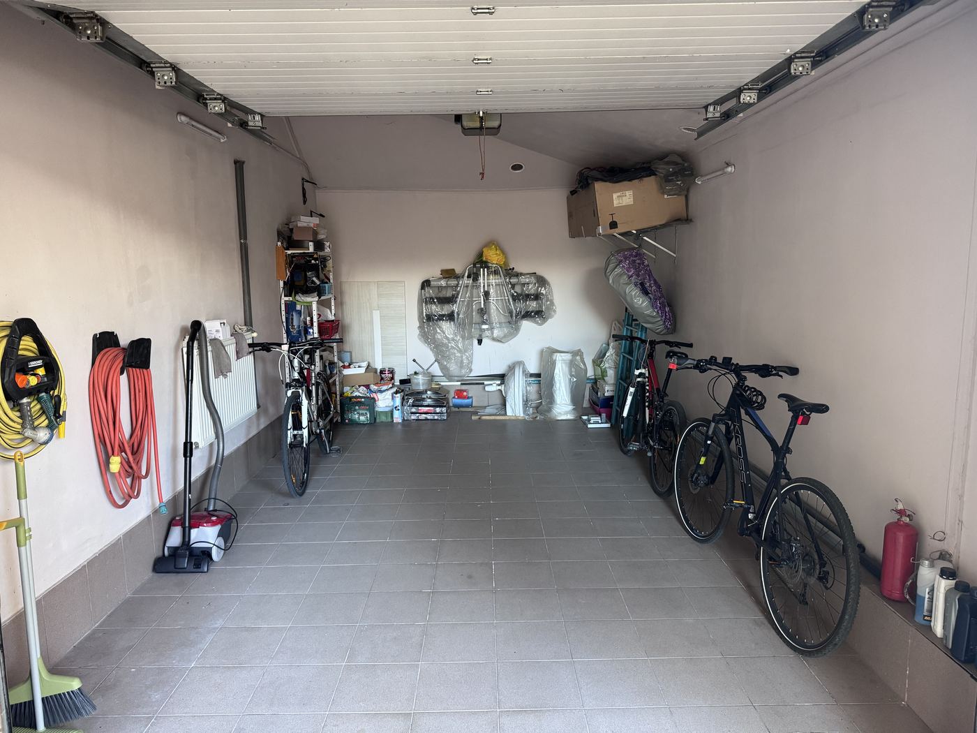Our garage, with the bikes, tools and the space the car takes up