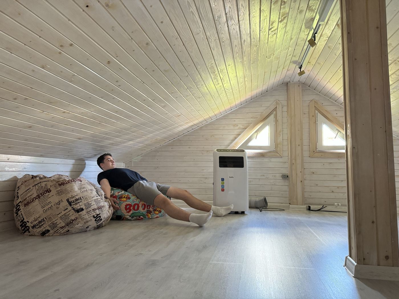 The finished floor, with bean bags under the slope and two triangular windows