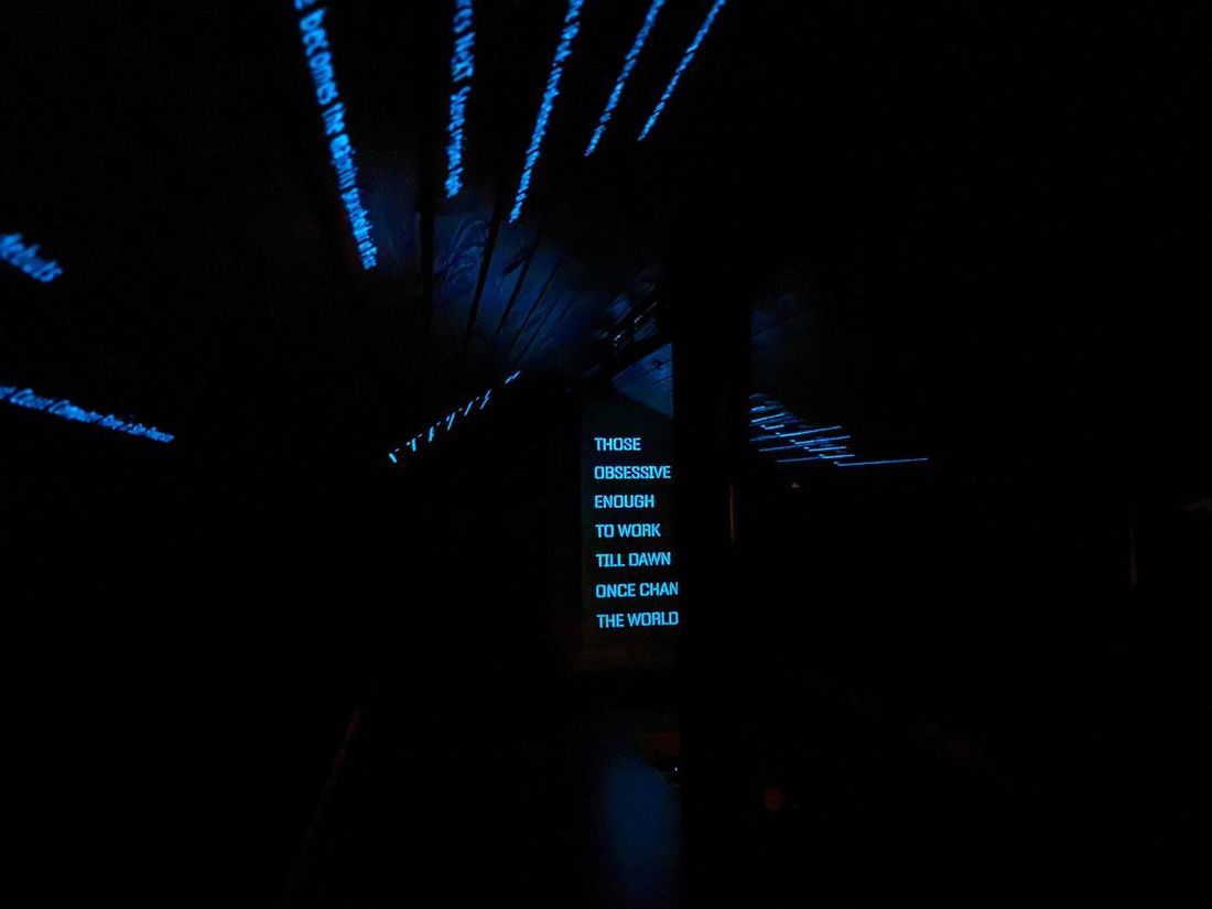In the dark the projector lights up the line those obsessive enough to work till dawn once change the world, with timelines running across the ceiling